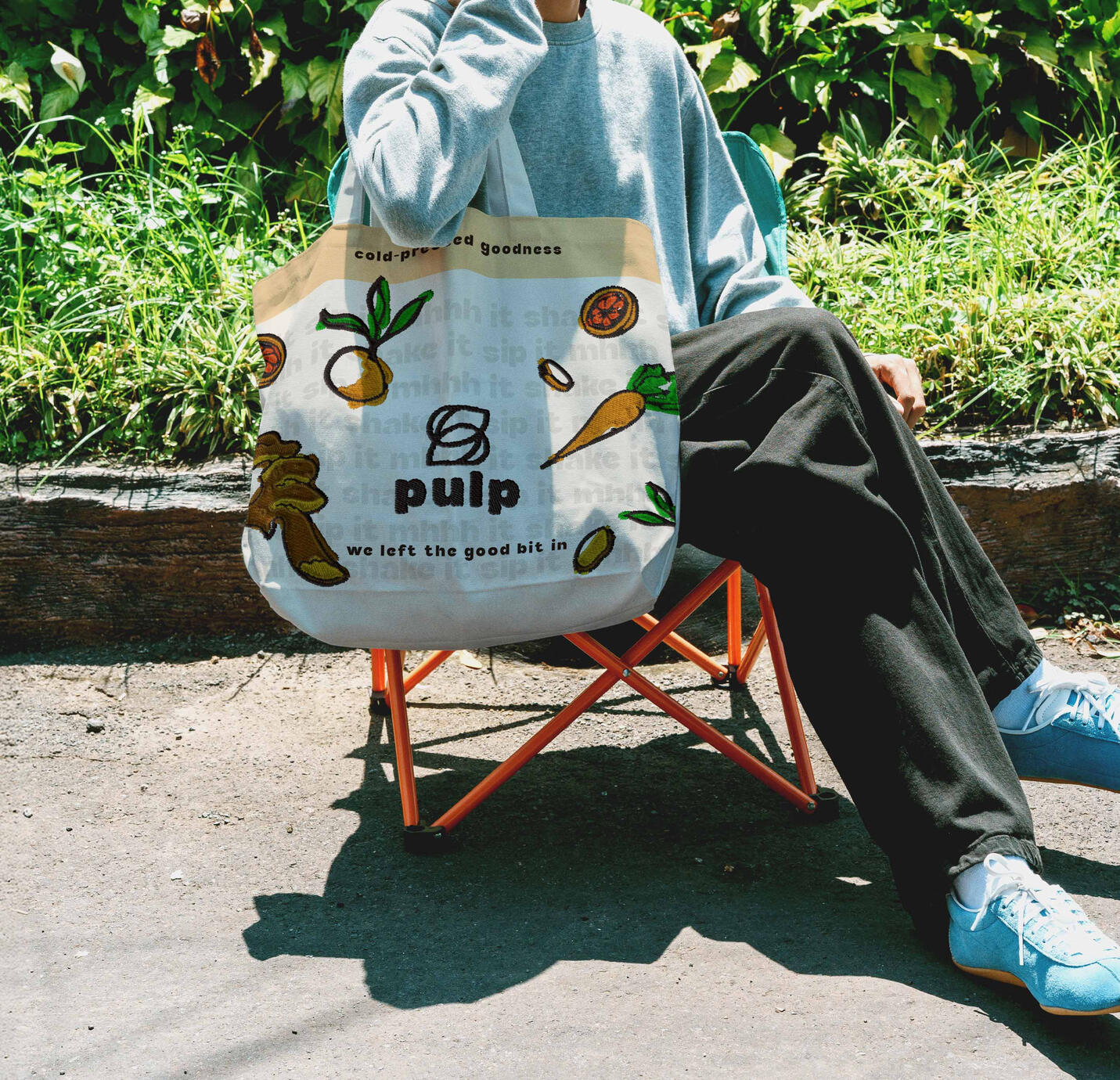 Concept design for the embroidered tote bag of a cold-pressed juice concept brand with logo, illustrated fruit and vegetable icons and the claims cold-pressed goodness and we left the good bit in