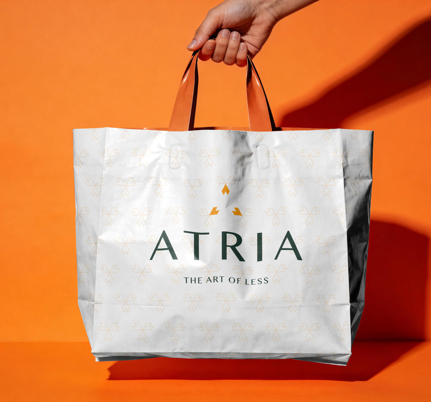 Concept design for the paper carrier bag of a premium lifestyle concept brand with wordmark, gold pattern print and the claim The Art of Less
